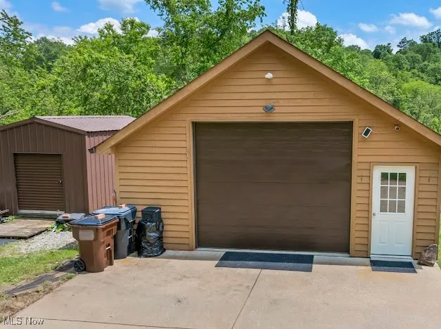 Detached garage with concrete driveway