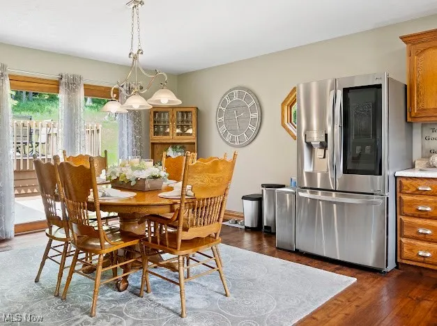 Dining area featuring dark wood finished floors