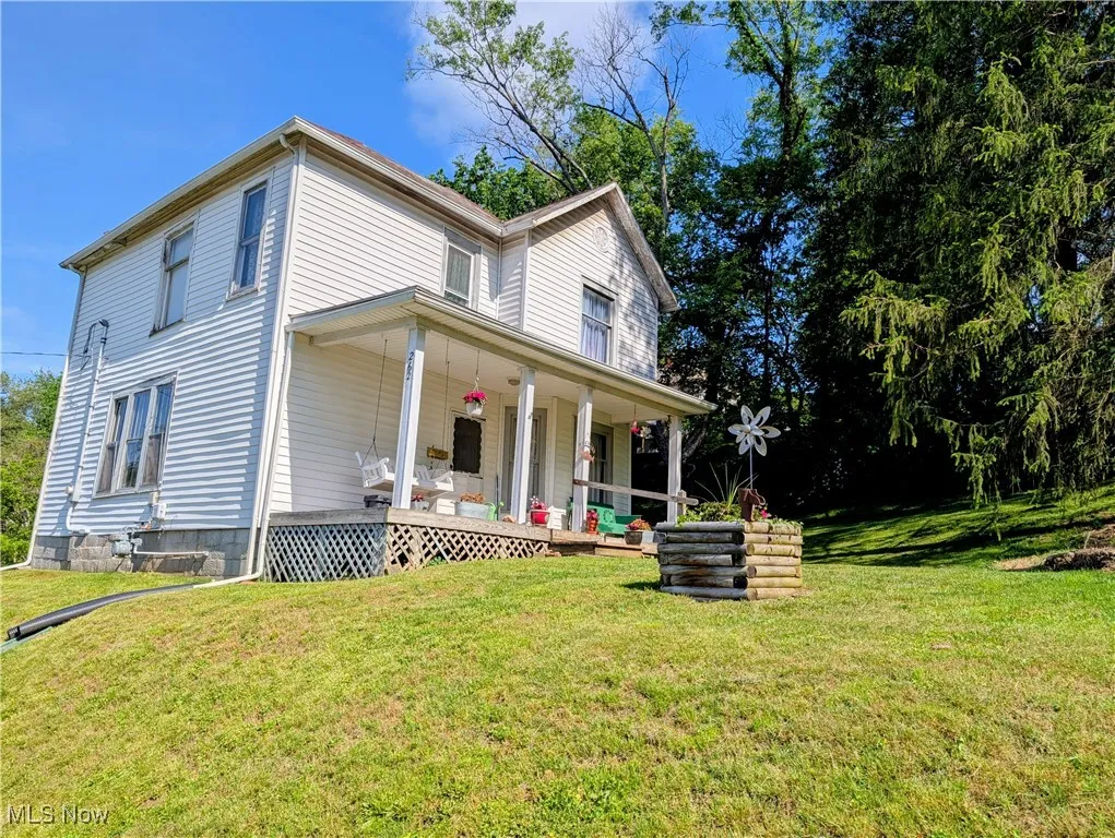 View of front of house with a porch and a front lawn