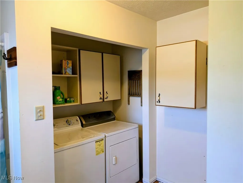 Clothes washing area with separate washer and dryer and cabinet space
