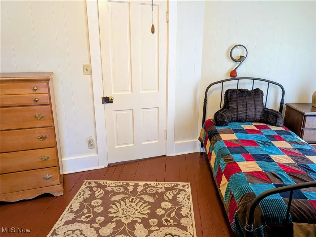Bedroom with dark wood-style floors
