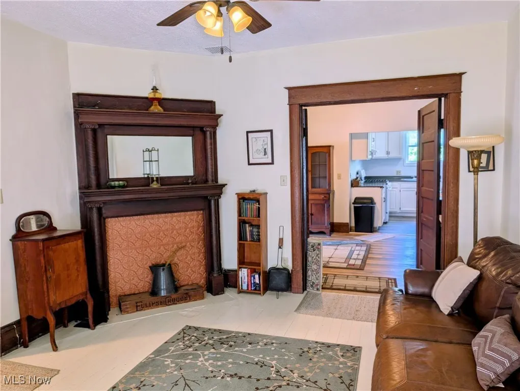 Living area with wood finished floors and ceiling fan