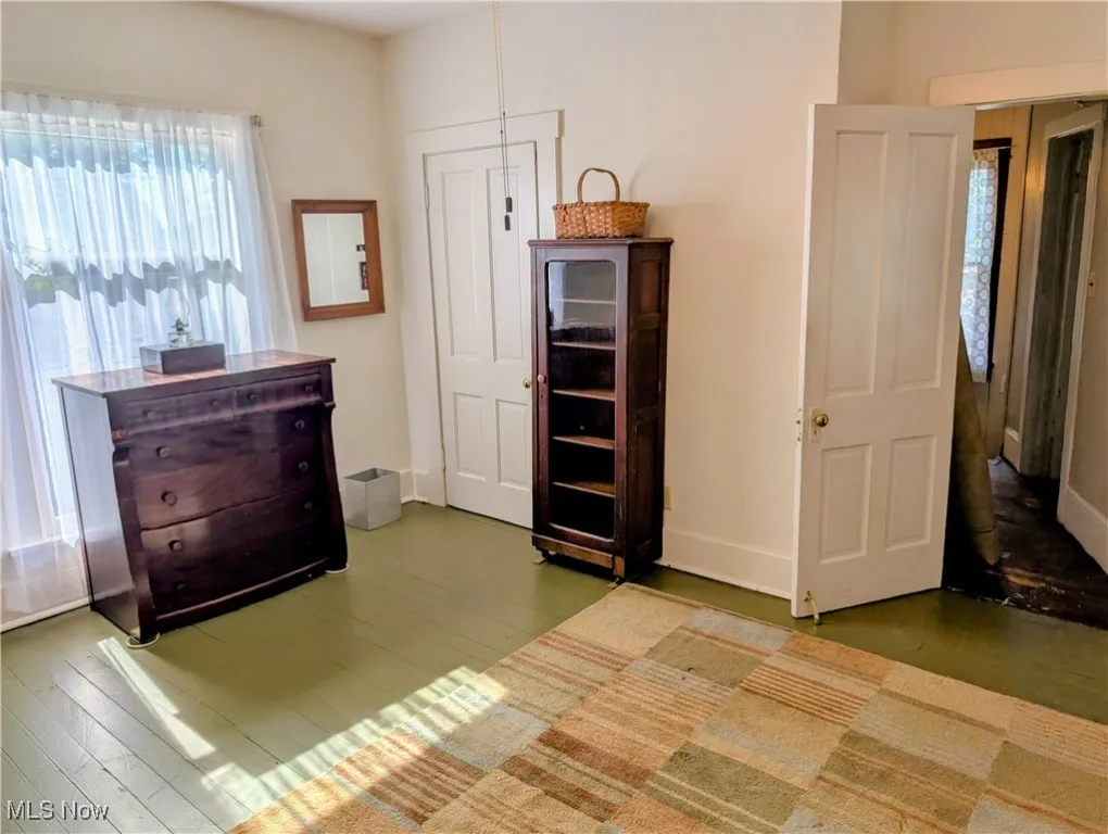 Bedroom featuring wood finished floors and baseboards
