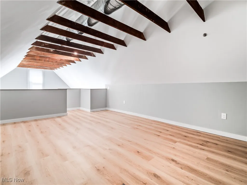 Bonus room/bedroom with baseboards and wood finished floors