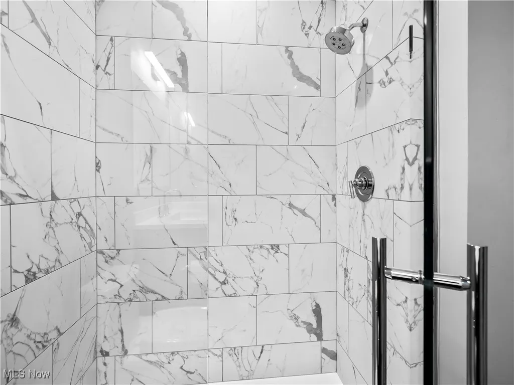 Full bath featuring tiled shower