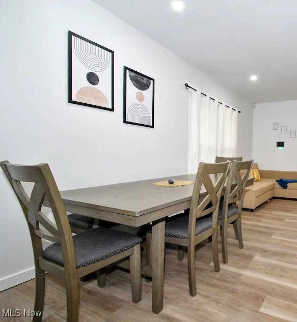 Dining space featuring light wood finished floors and recessed lighting
