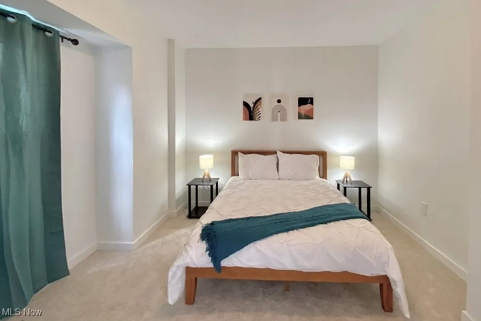 Bedroom with carpet flooring and baseboards