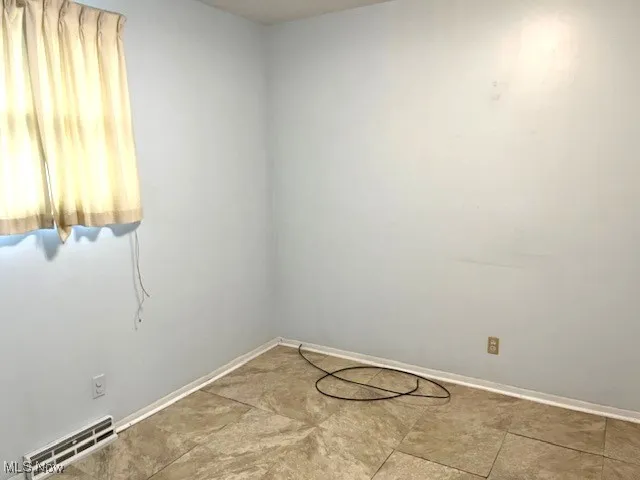 Unfurnished room featuring baseboards