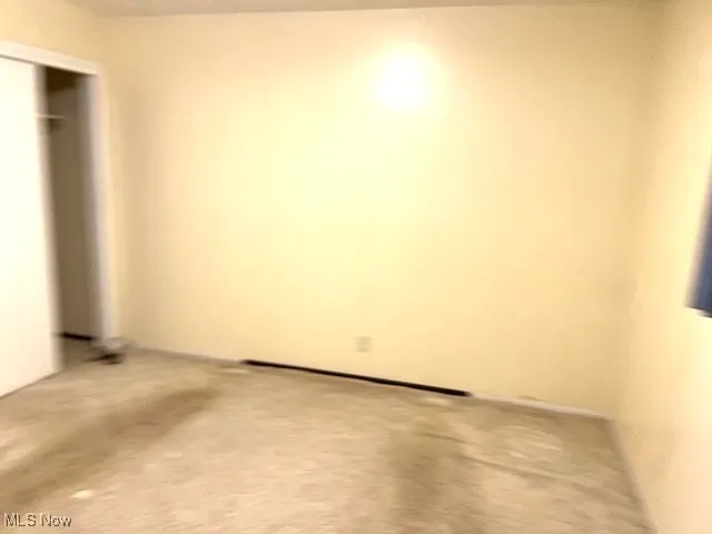 Unfurnished bedroom featuring a closet and carpet