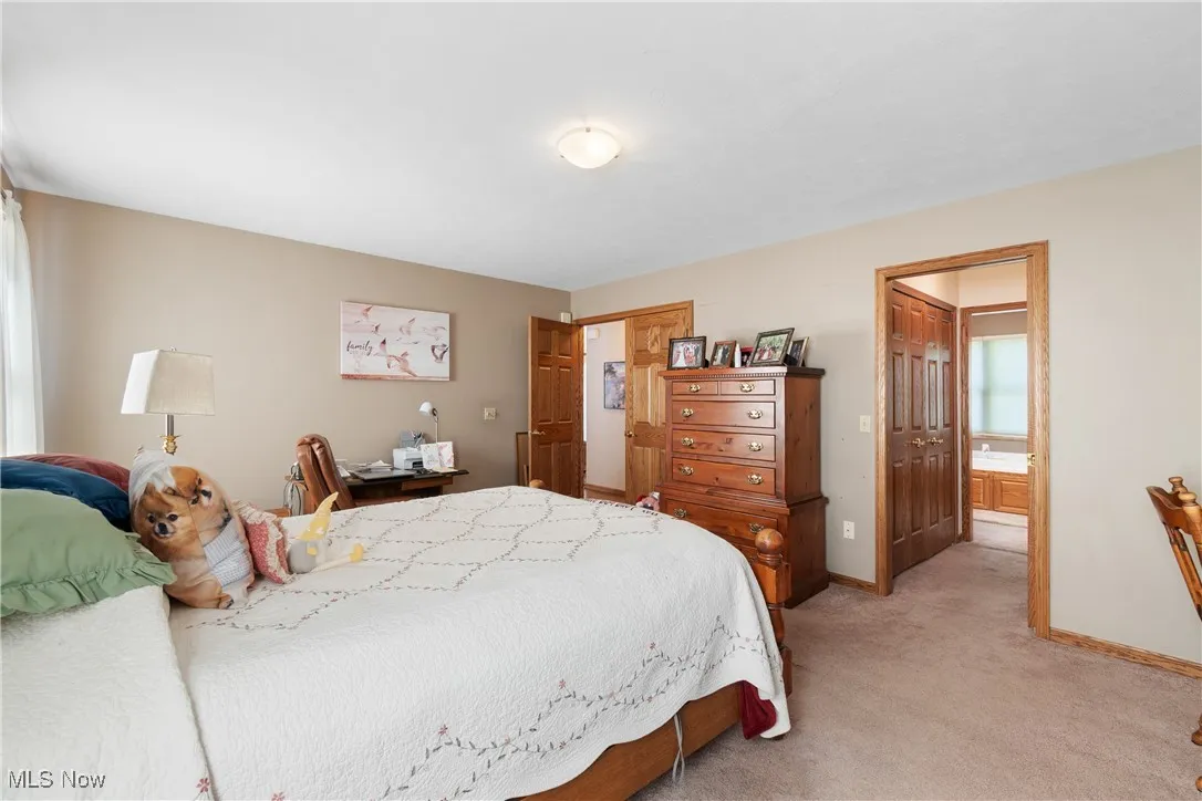 Bedroom with light carpet and baseboards