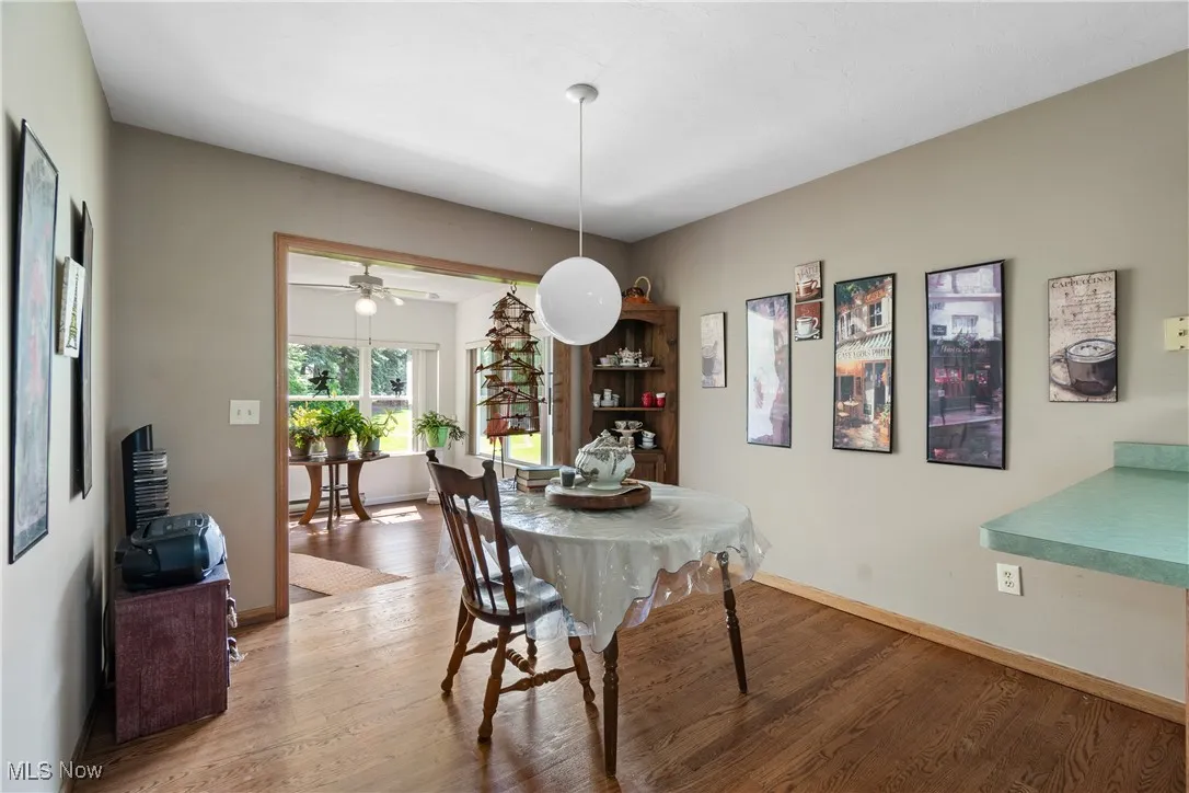Dining space with light wood-type flooring and baseboards