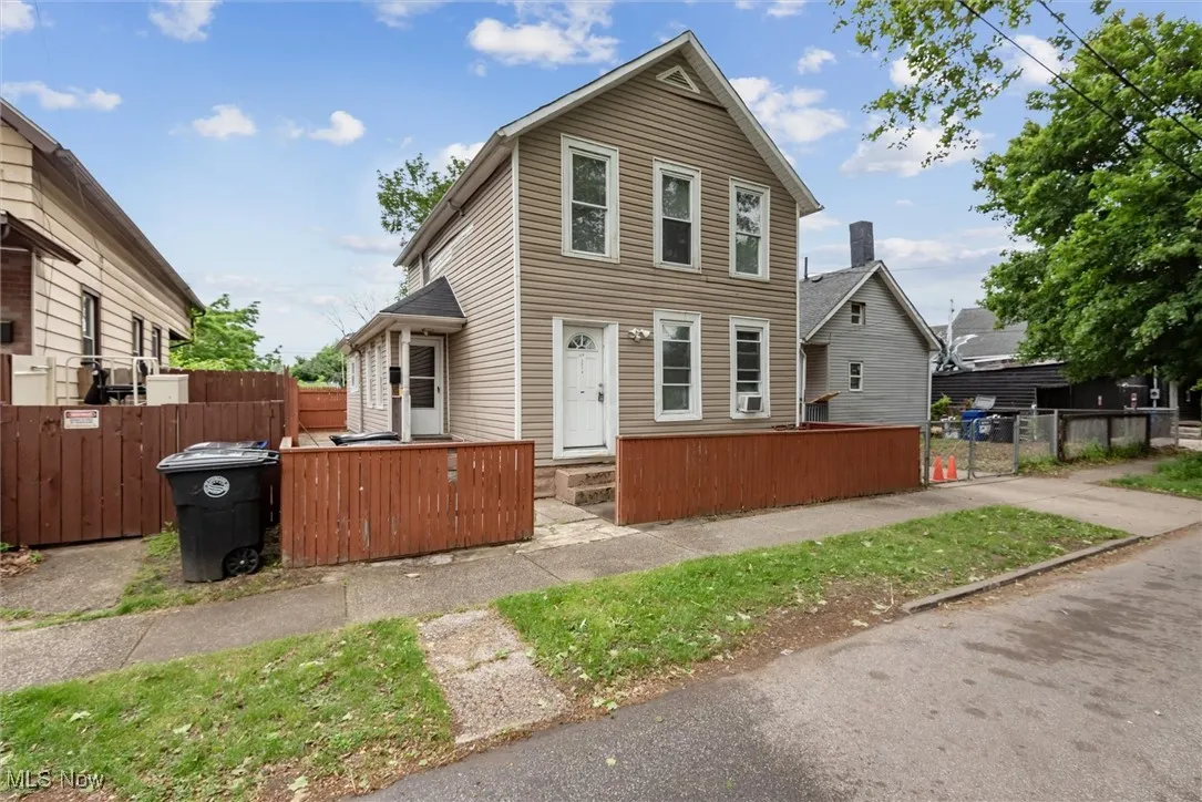View of front of property featuring fence, a gate, and entry steps