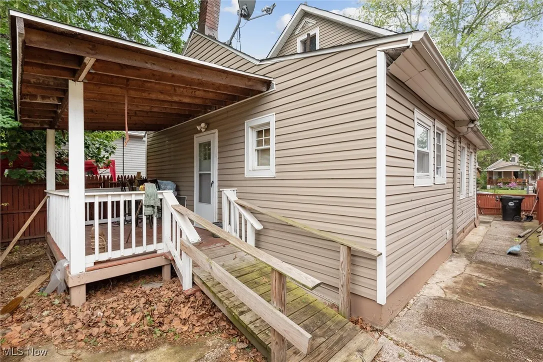 View of side of property featuring a chimney and a deck