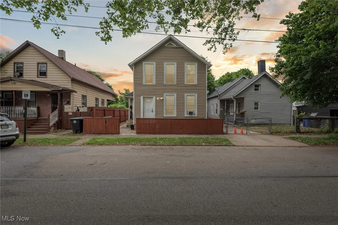 View of front of house featuring a gate and fence