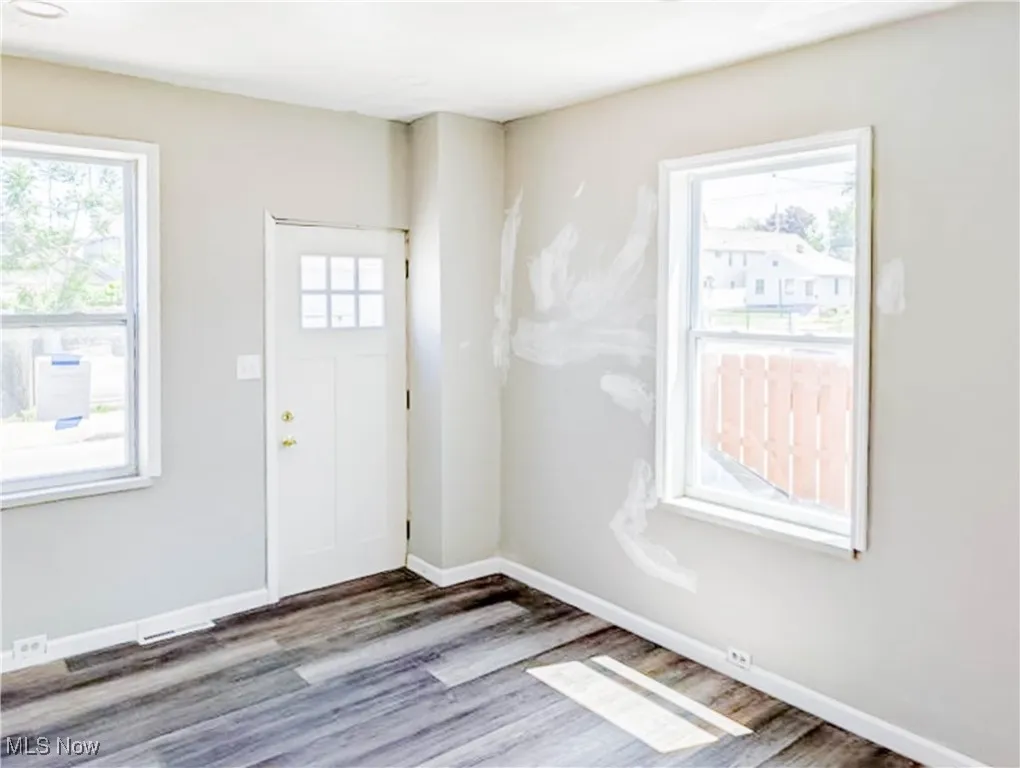 Foyer with wood finished floors and baseboards