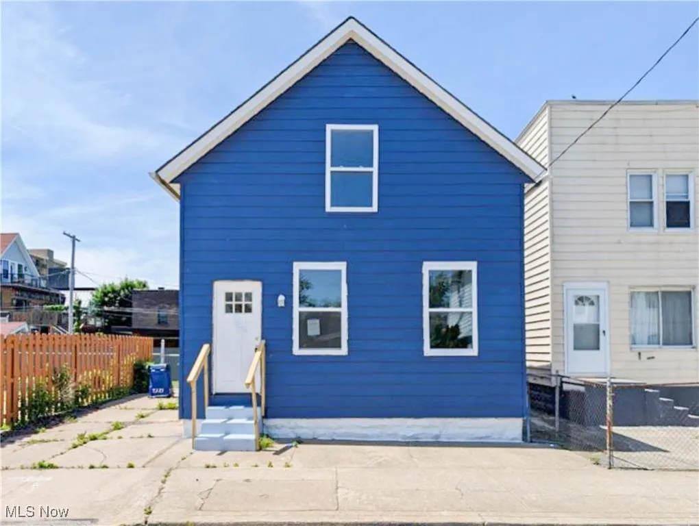 Rear view of house featuring entry steps
