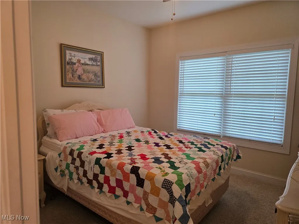 Carpeted bedroom with baseboards
