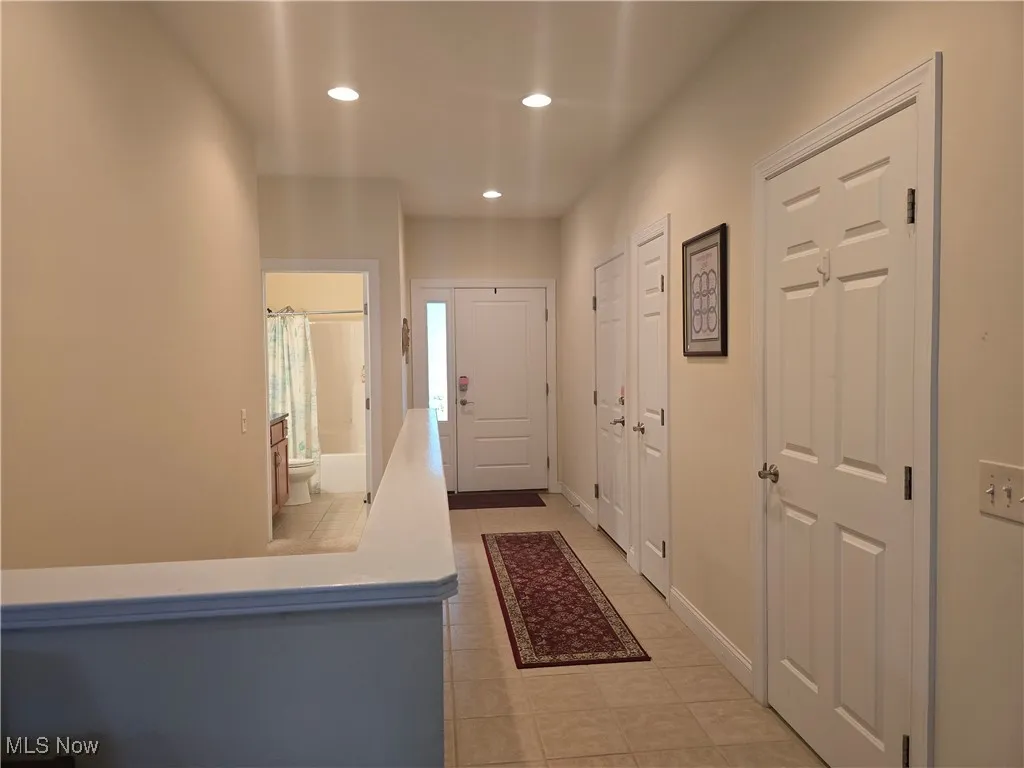Entryway featuring light tile patterned flooring and recessed lighting