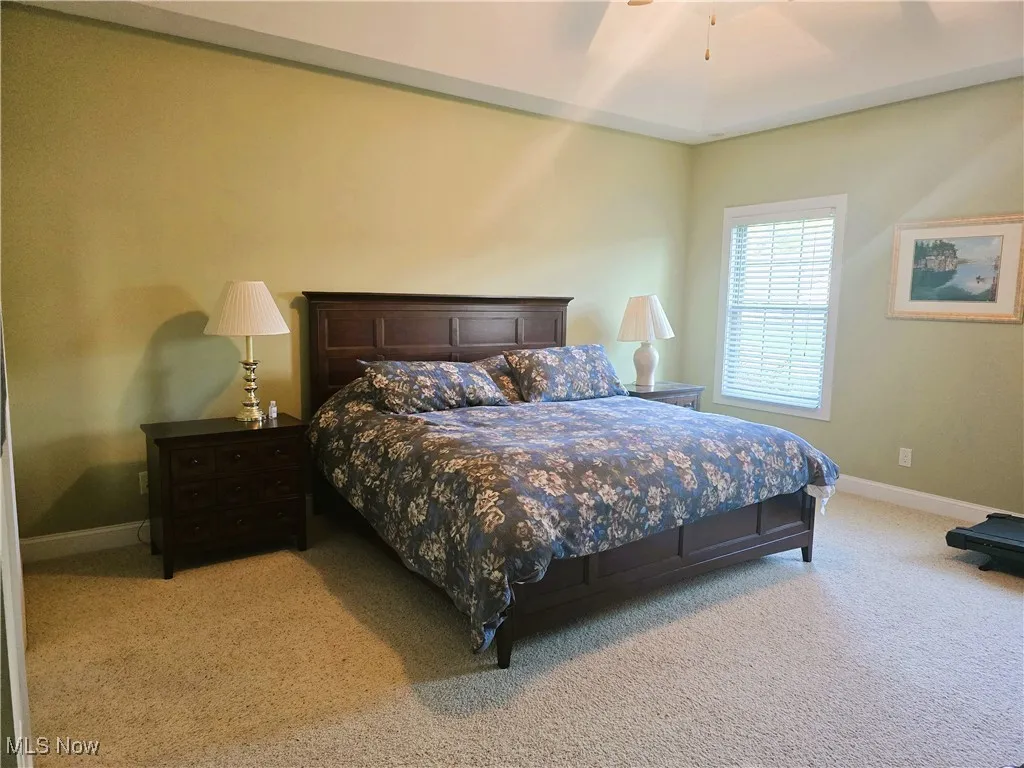 Owner suite Bedroom with trayed ceilings, ceiling fan, double door entry off great room.