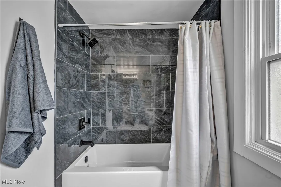Full bath featuring shower / tub combo