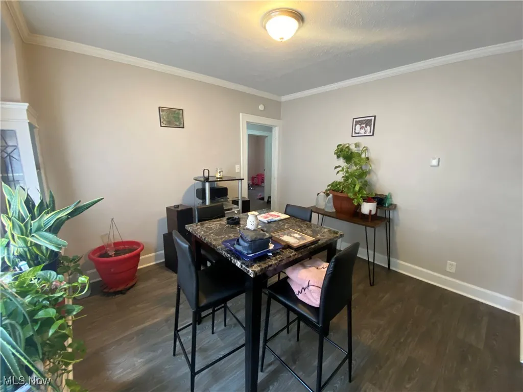 Dining room featuring crown molding and wood finished floors