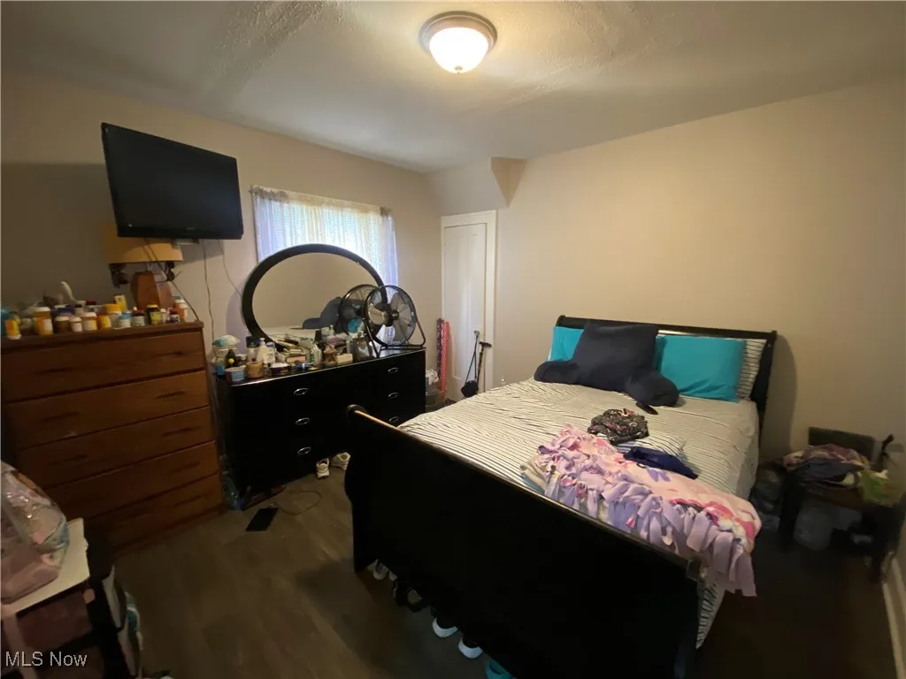 Bedroom featuring dark wood finished floors and a textured ceiling