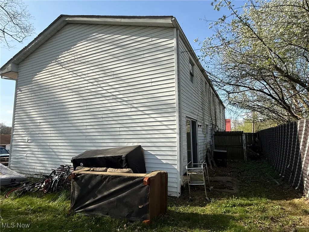 View of home's exterior back with​​‌​​​​‌​​‌‌​‌‌​​​‌‌​‌​‌​‌​​​‌​​ fence
