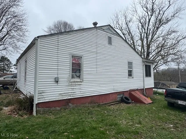 View of home's exterior with a yard