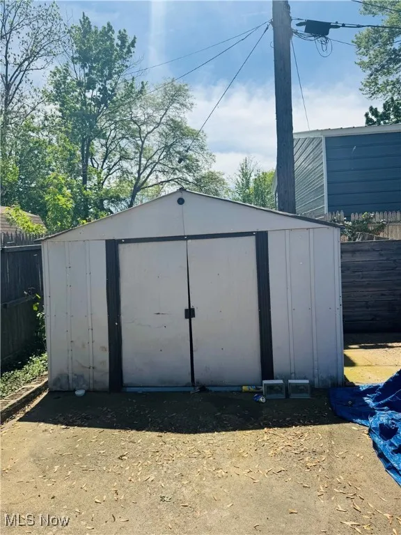 View of shed featuring fence