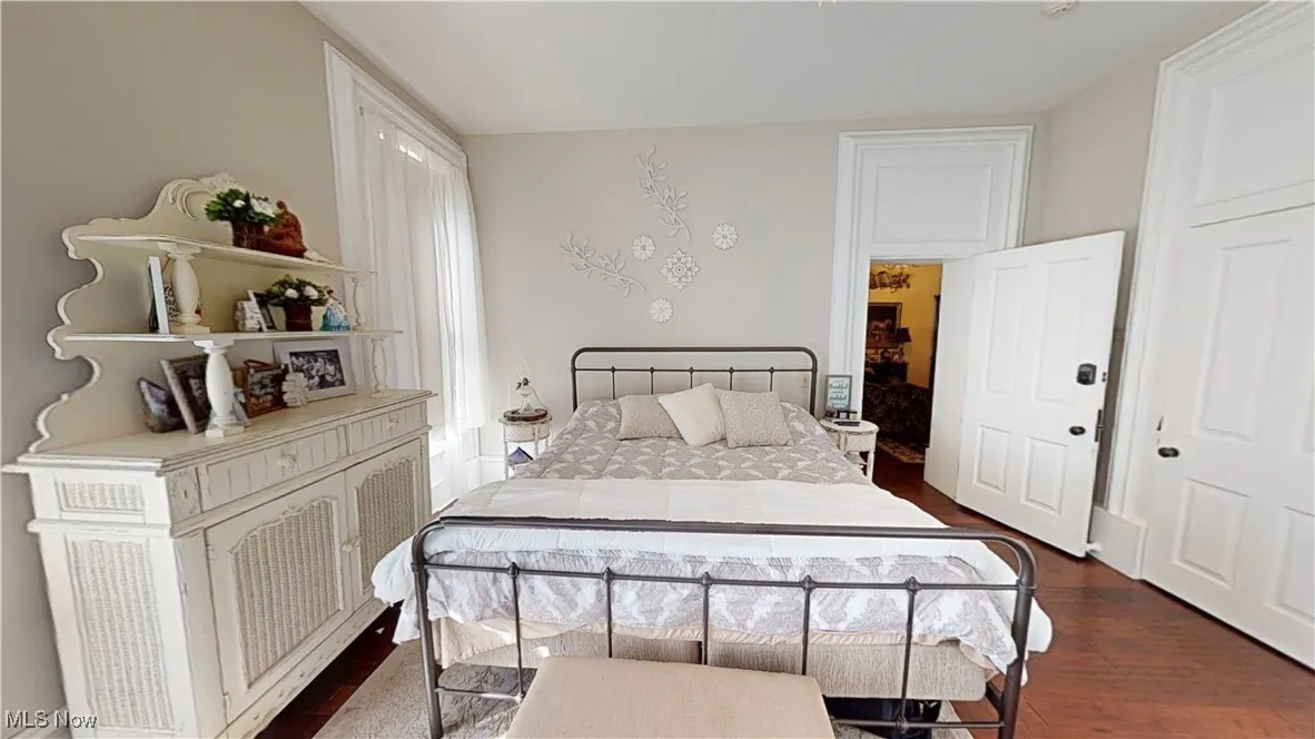 Bedroom with a closet and dark hardwood / wood-style flooring