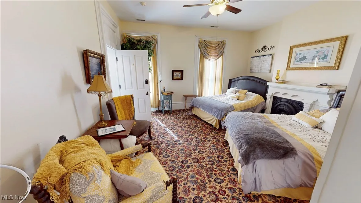 Carpeted bedroom with ceiling fan
