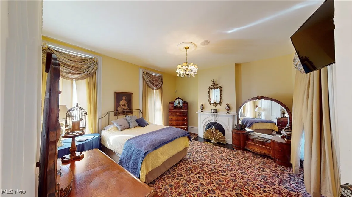 Bedroom with an inviting chandelier and carpet floors