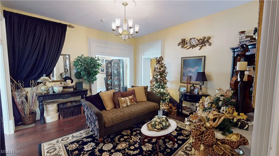 Living room with wood-type flooring and a chandelier
