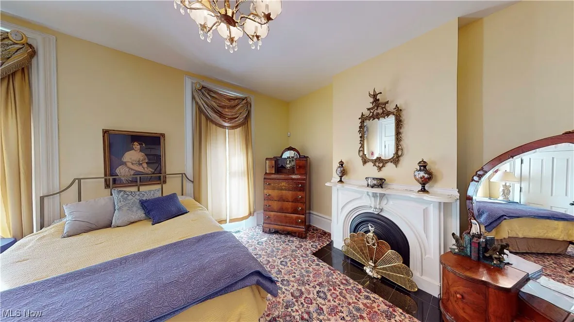 Bedroom featuring wood-type flooring and a notable chandelier