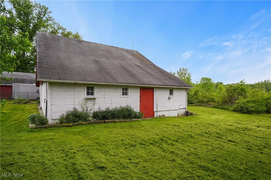Back of property with a shingled roof