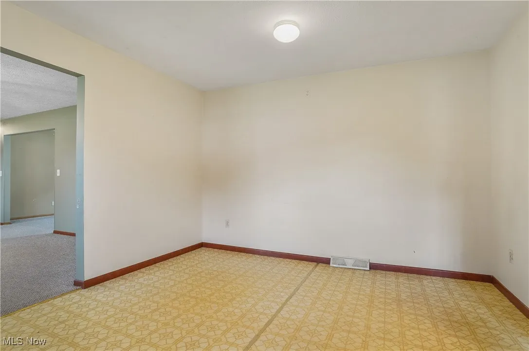 Unfurnished room featuring baseboards and tile patterned floors