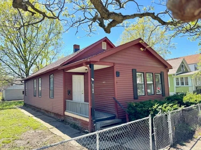 Front of home, fenced yard