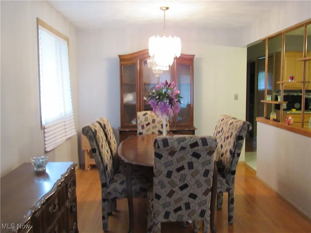 Dining area featuring a chandelier and wood finished floors