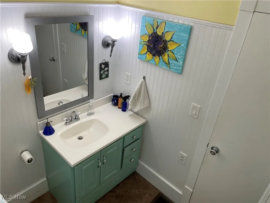Bathroom featuring tile patterned flooring and vanity