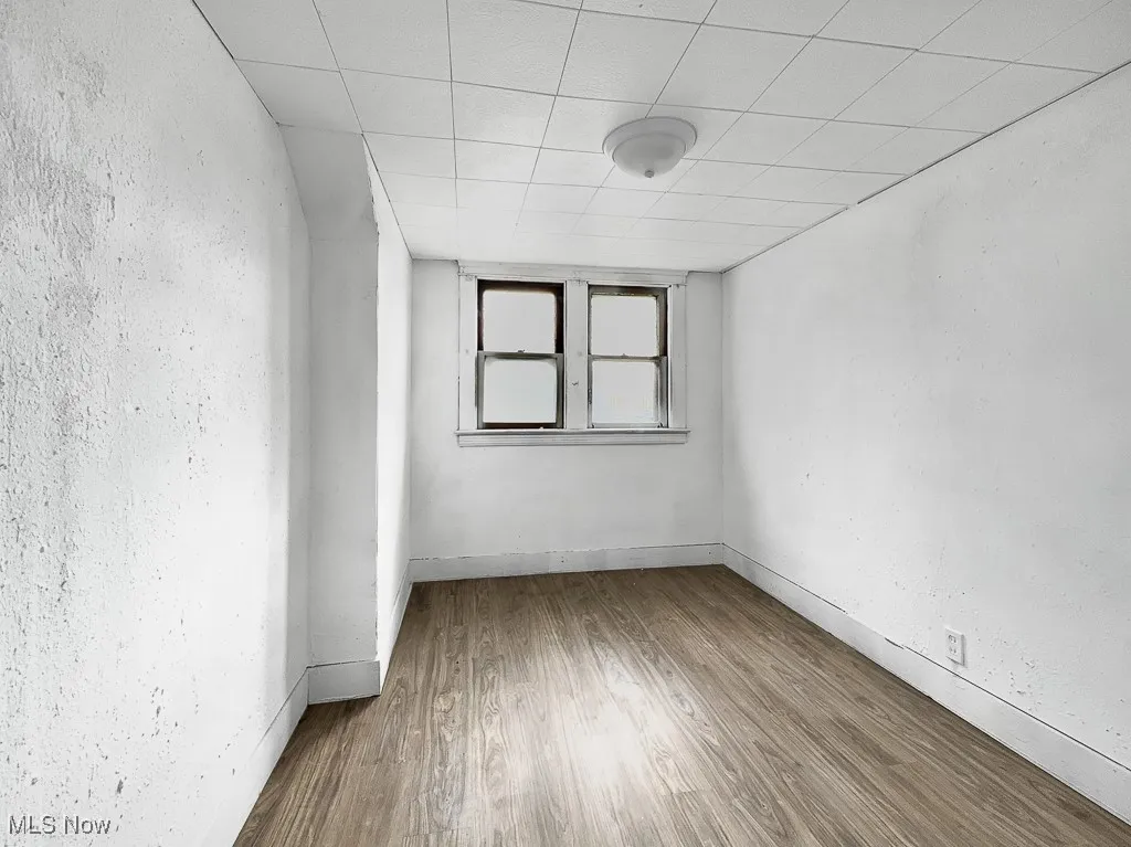 Empty room featuring wood finished floors and baseboards