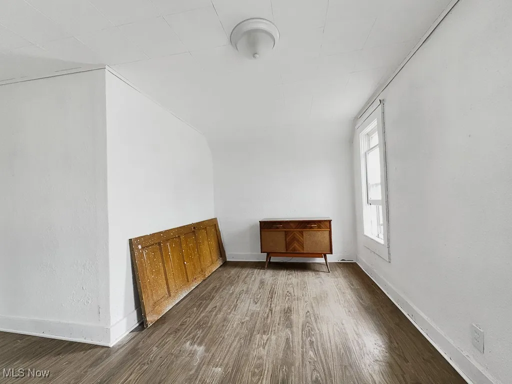 Empty room with wood finished floors and baseboards