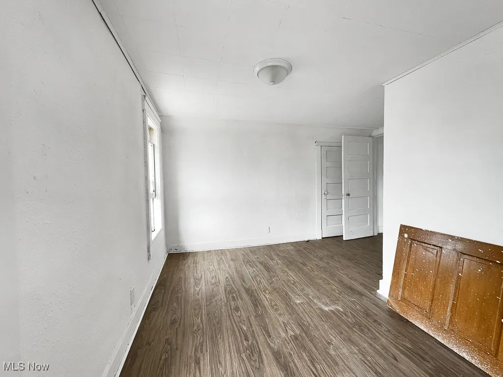 Empty room with wood finished floors and baseboards