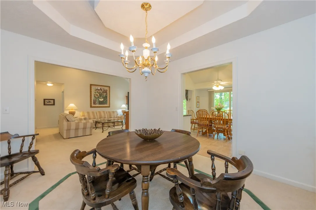 Dining room with a chandelier and light carpet