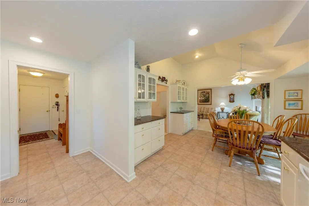 Dining room featuring a ceiling fan, vaulted ceiling, and recessed lighting
