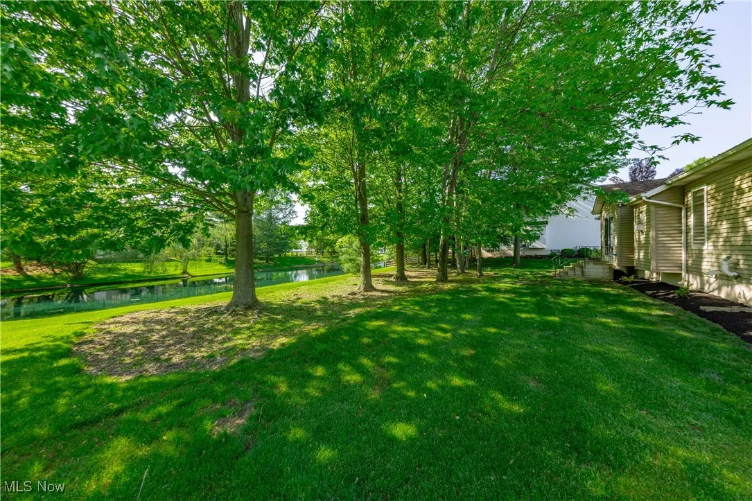 View of green lawn with a water view