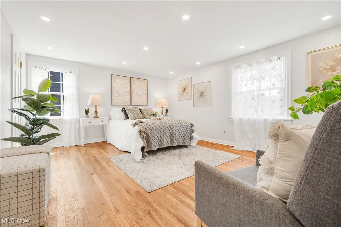 Bedroom with wood finished floors, recessed lighting, and baseboards