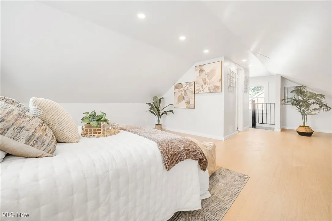Bedroom with recessed lighting, baseboards, wood finished floors, and lofted ceiling