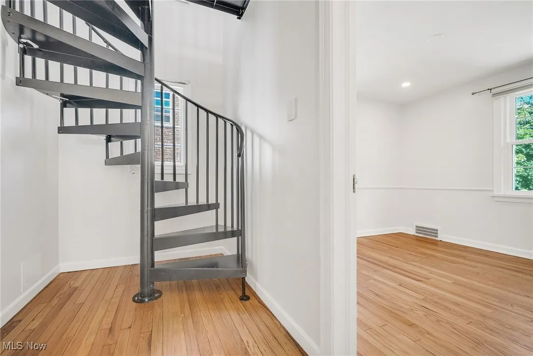 Staircase with wood-type flooring, baseboards, and recessed lighting