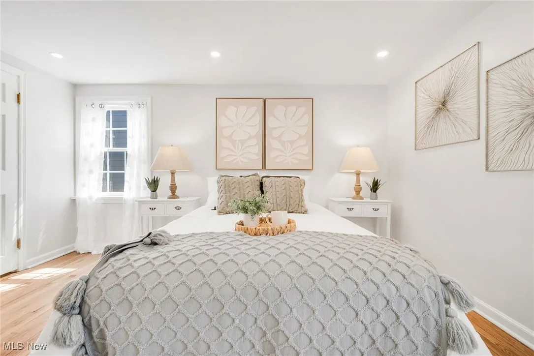Bedroom featuring light wood-style floors, baseboards, and recessed lighting