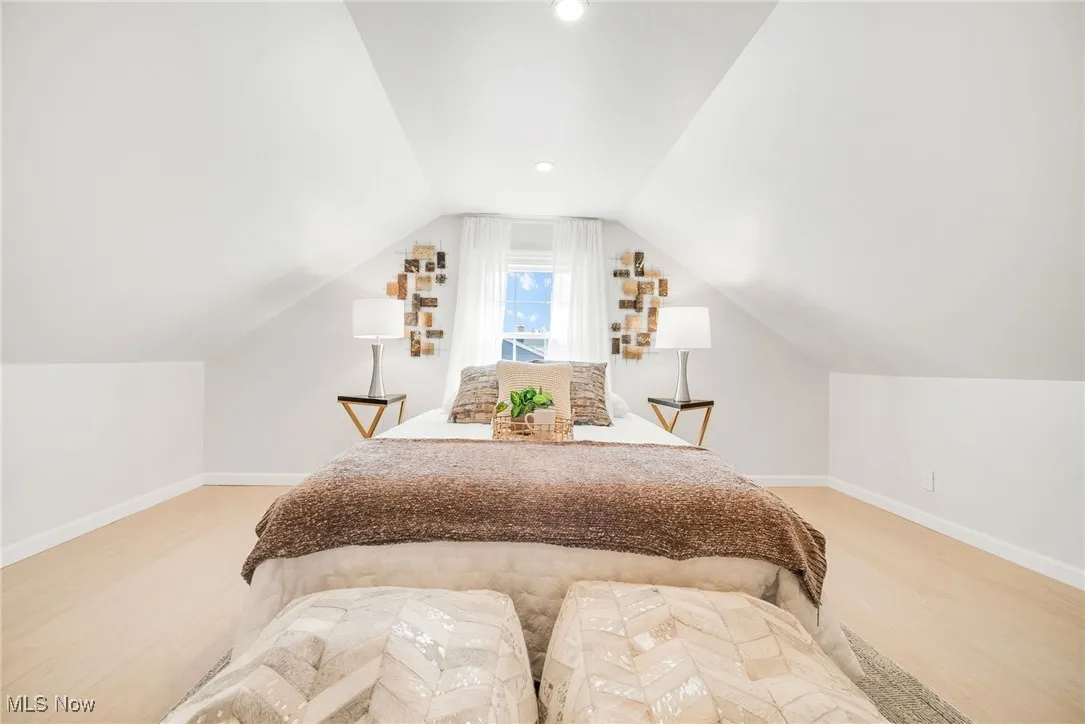 Bedroom featuring baseboards, lofted ceiling, and recessed lighting